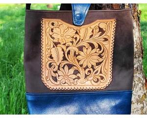 Hand Carved & finished outside pocket hand sewn onto the front of the bag.